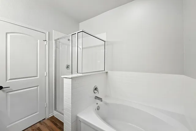 a bathroom with a bathtub and a shower