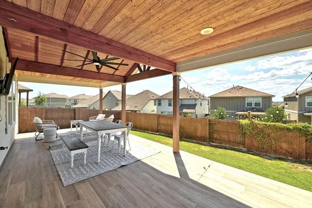 a view of a patio with a dining table and chairs