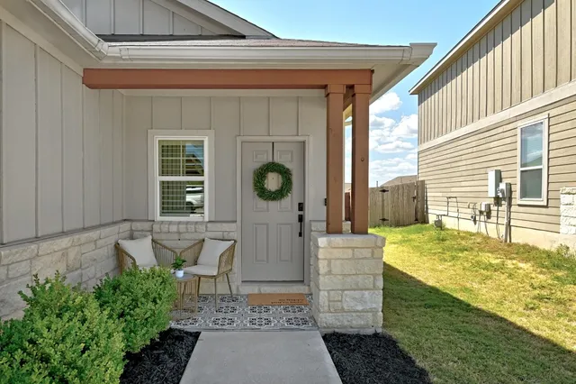 a view of a porch with a table and chairs