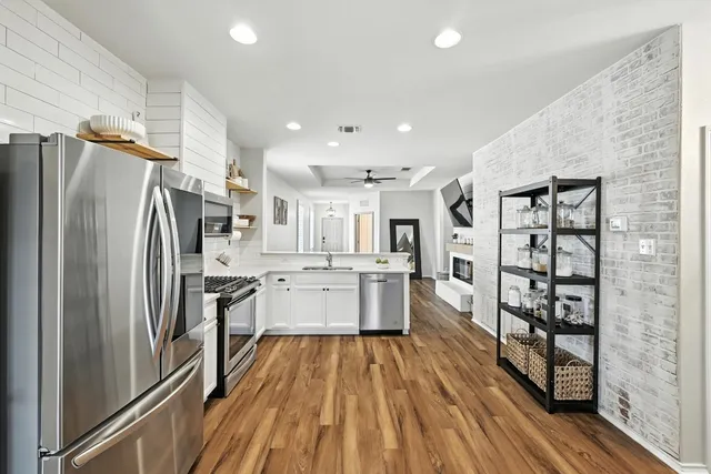a kitchen with refrigerator a sink and cabinets