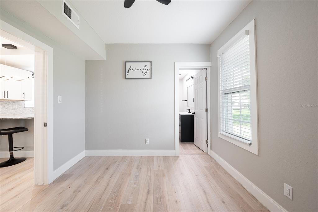 922 Delaware Avenue St. Cloud, FL 34769 - Photo 12 of 31 a view of an empty room with wooden floor and a window