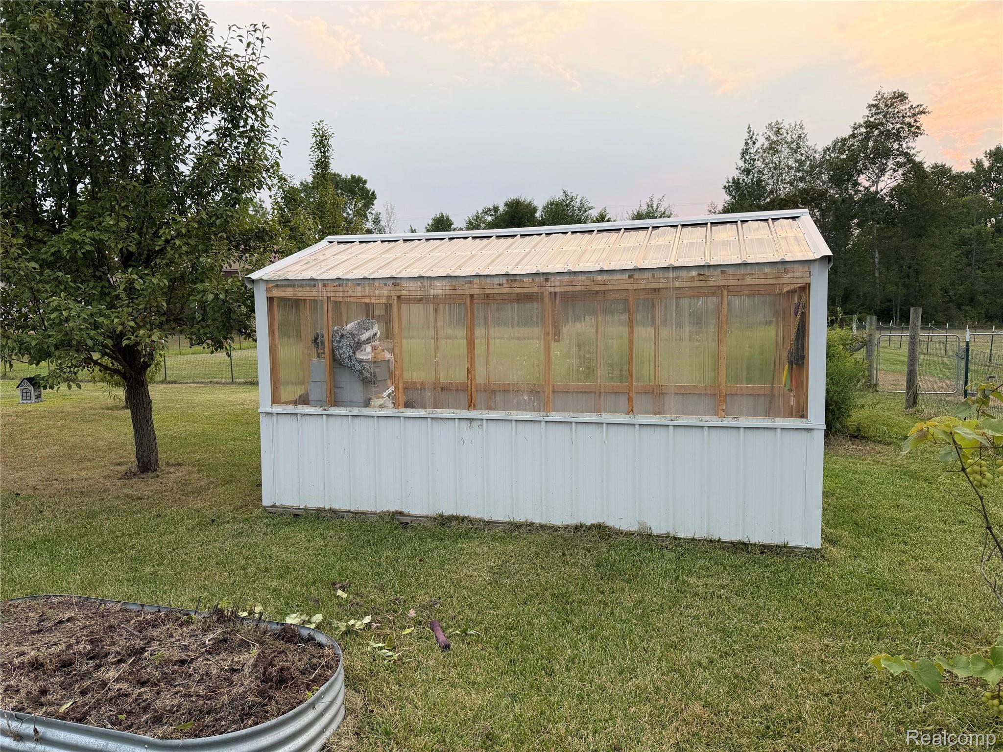 2402 Mertz Road Caro, MI 48723 - Photo 19 of 26 Greenhouse with a metal roof and translucent paneling