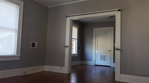 an empty room with wooden floor and closet