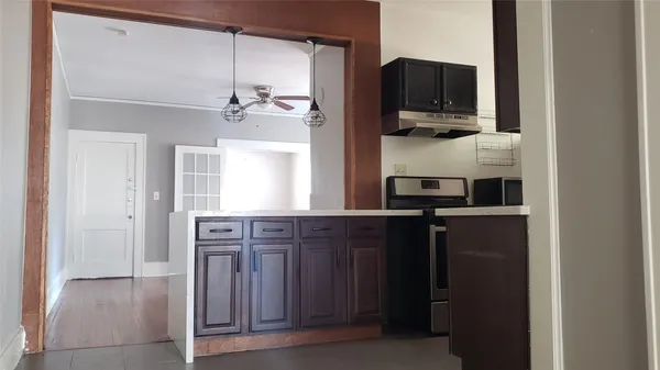 a kitchen with a refrigerator and a stove top oven