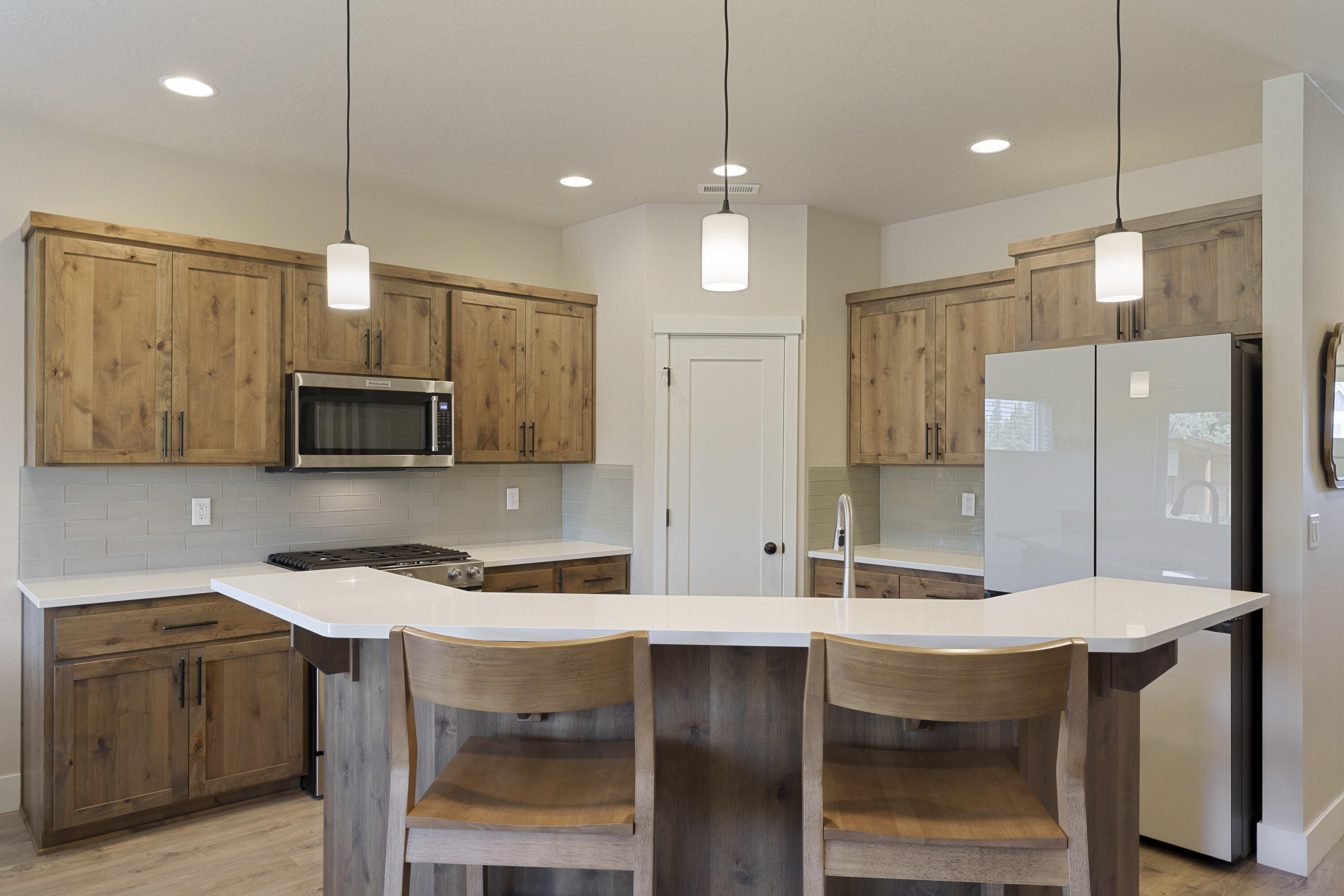 4999 Southwest Yew Place Redmond, OR 97756 - Photo 11 of 50 a kitchen with stainless steel appliances granite countertop a sink refrigerator and microwave