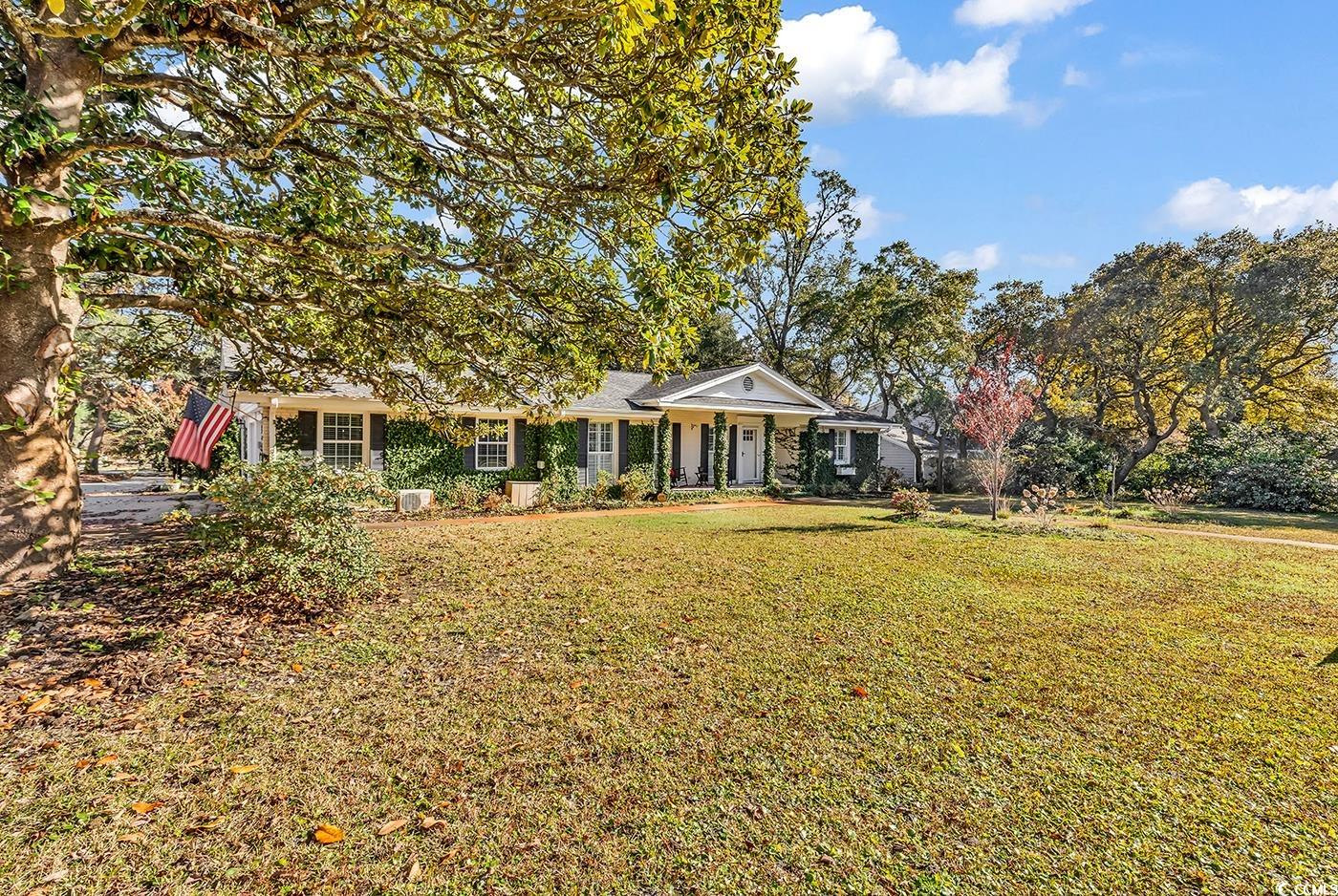 Rear view of house featuring a lawn