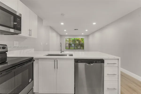 a kitchen with a sink and cabinets