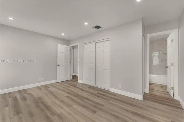 a view of hallway with wooden floor