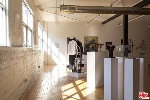a view of a room with wooden floor and windows