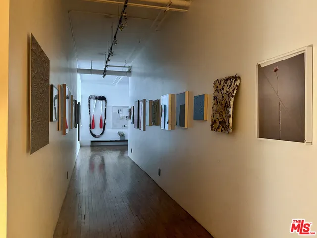 a bathroom with a toilet sink vanity and mirror