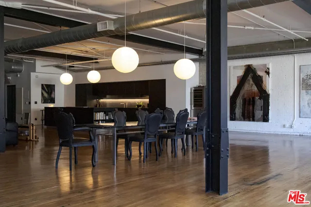 a kitchen with a sink and a wooden floor