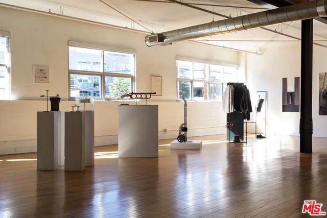 a view of a living room with furniture and wooden floor