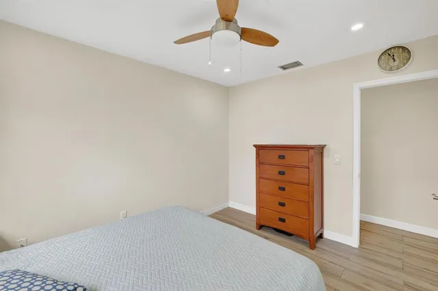 a room with a dresser and a chandelier
