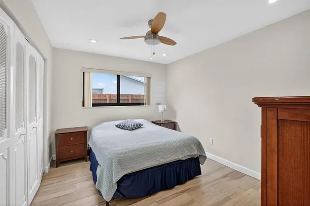 a bedroom with a bed and a painting on the wall