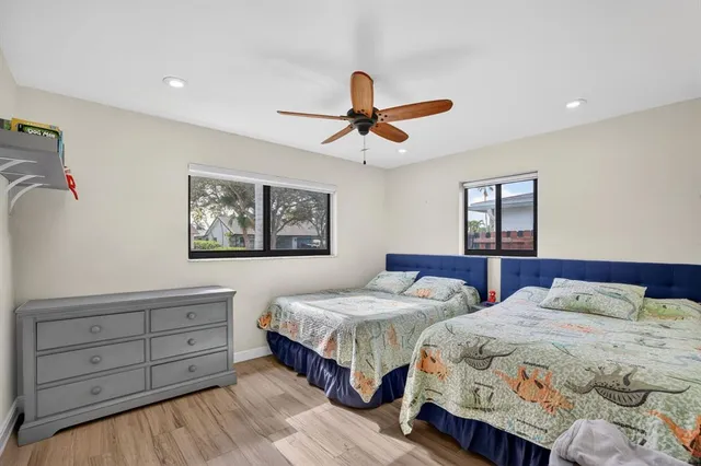 a bedroom with two beds and a chandelier