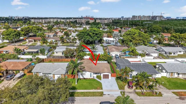 an aerial view of residential houses with outdoor space and river