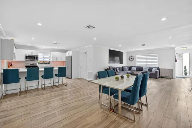 a view of a dining room with furniture and wooden floor