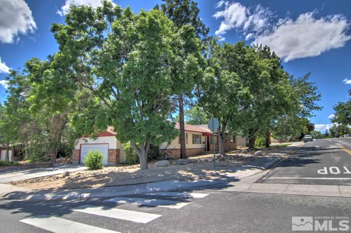 1300 Grandview Avenue Reno, NV 89503 - Photo 1 of 18 a front view of a house with a yard and garage