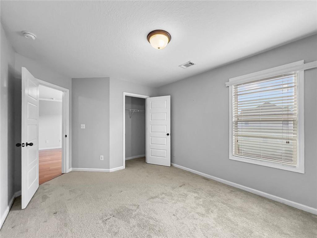 6 Pebblebrook Lane Fort Mitchell, AL 36856 - Photo 30 of 48 Unfurnished bedroom featuring carpet, a closet, and a textured ceiling