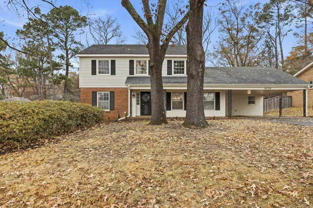 front view of a house with a bench