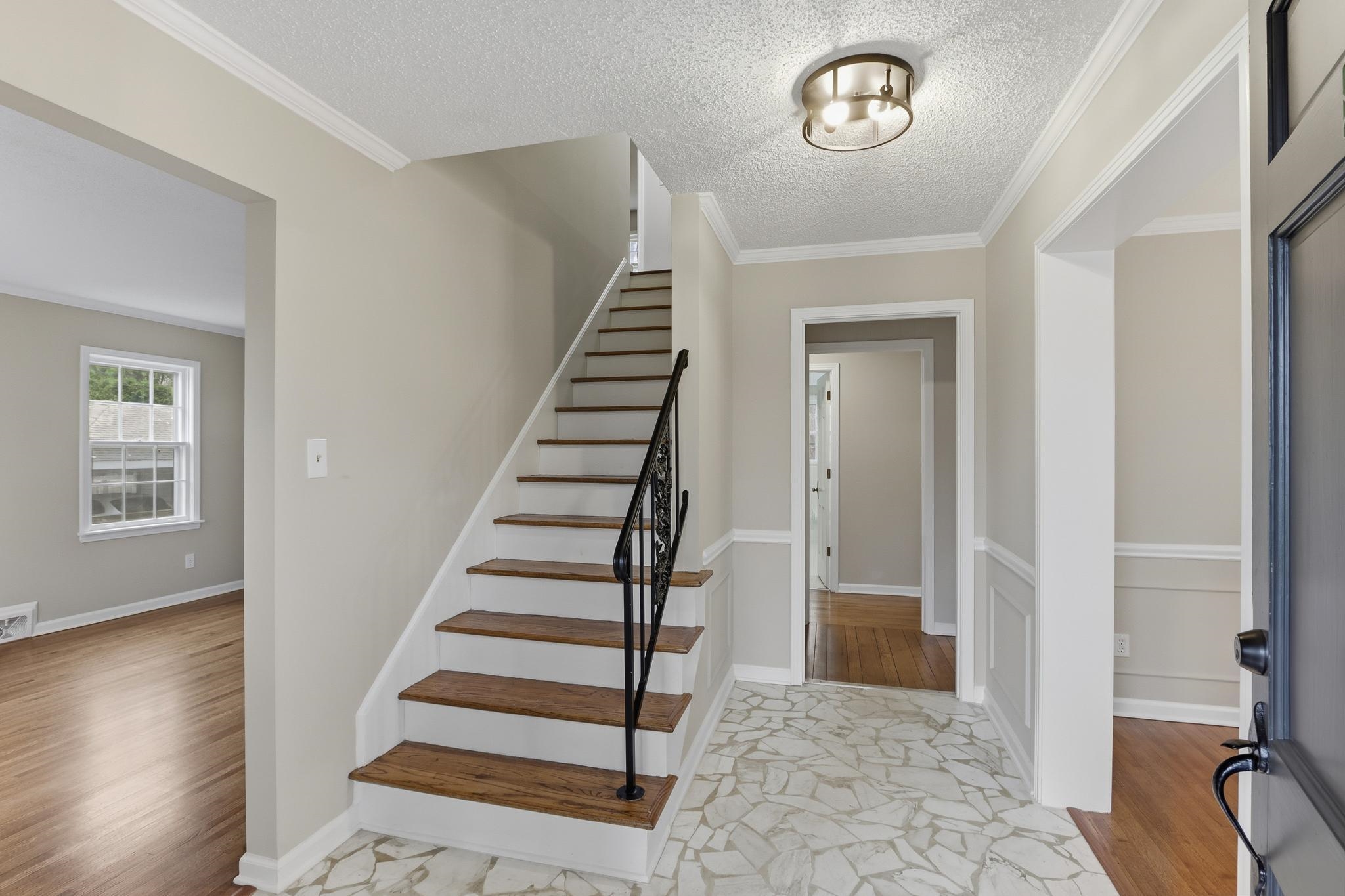 6436 Messick Road Memphis, TN 38119 - Photo 4 of 40 Stairs with crown molding, wood finished floors, and a textured ceiling
