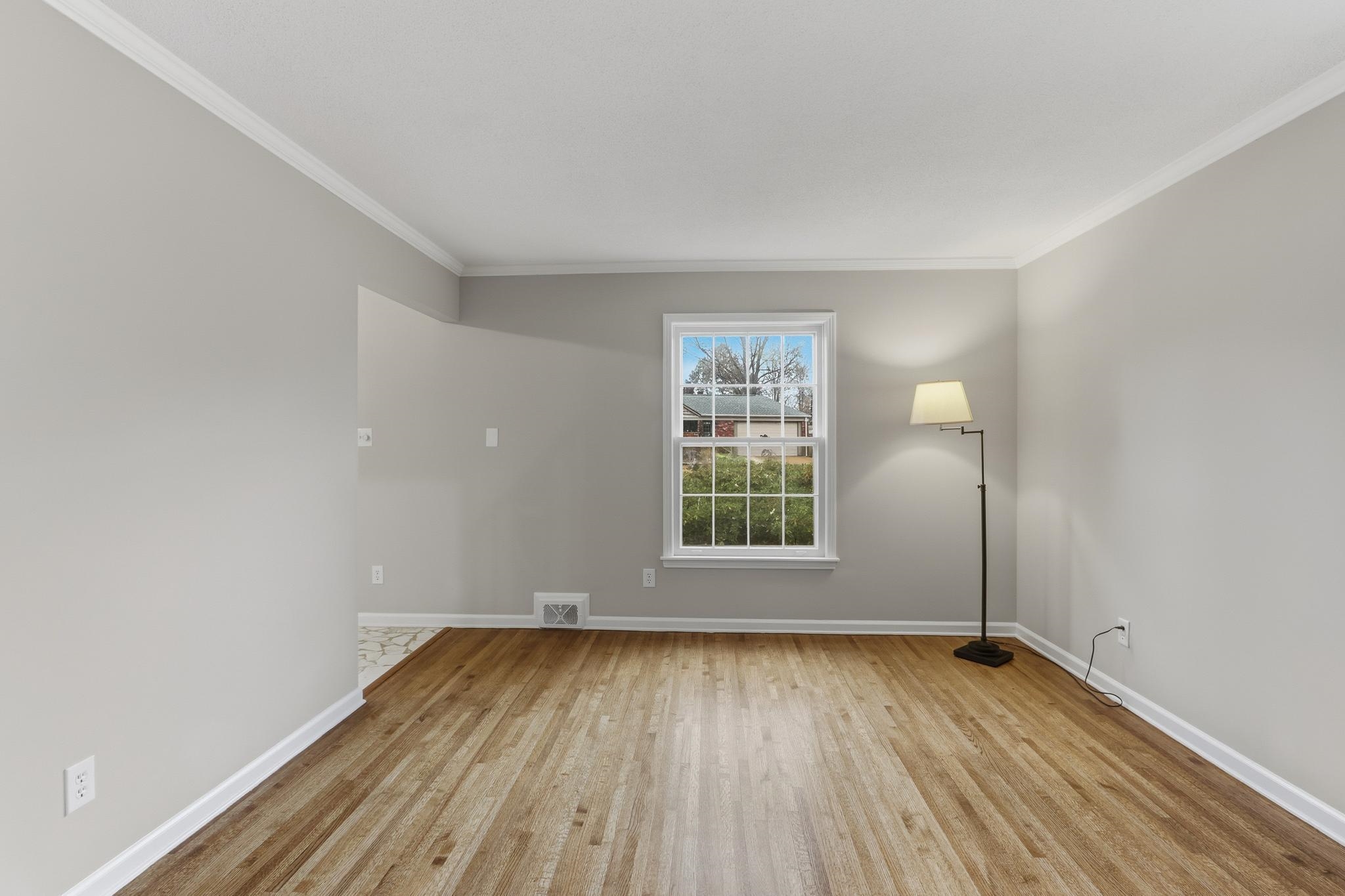 6436 Messick Road Memphis, TN 38119 - Photo 9 of 40 Empty room featuring ornamental molding and light wood finished floors