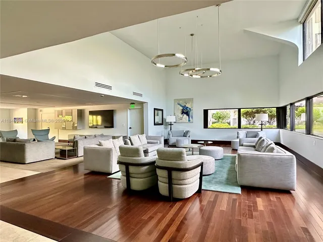 a living room with fireplace furniture and a large window