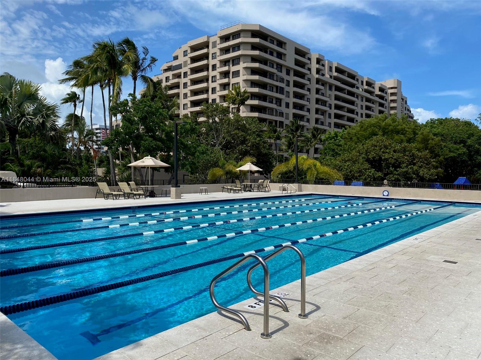 251 Crandon Boulevard, Unit 243 Key Biscayne, FL 33149 - Photo 21 of 23 a view of a chair and table in the backyard