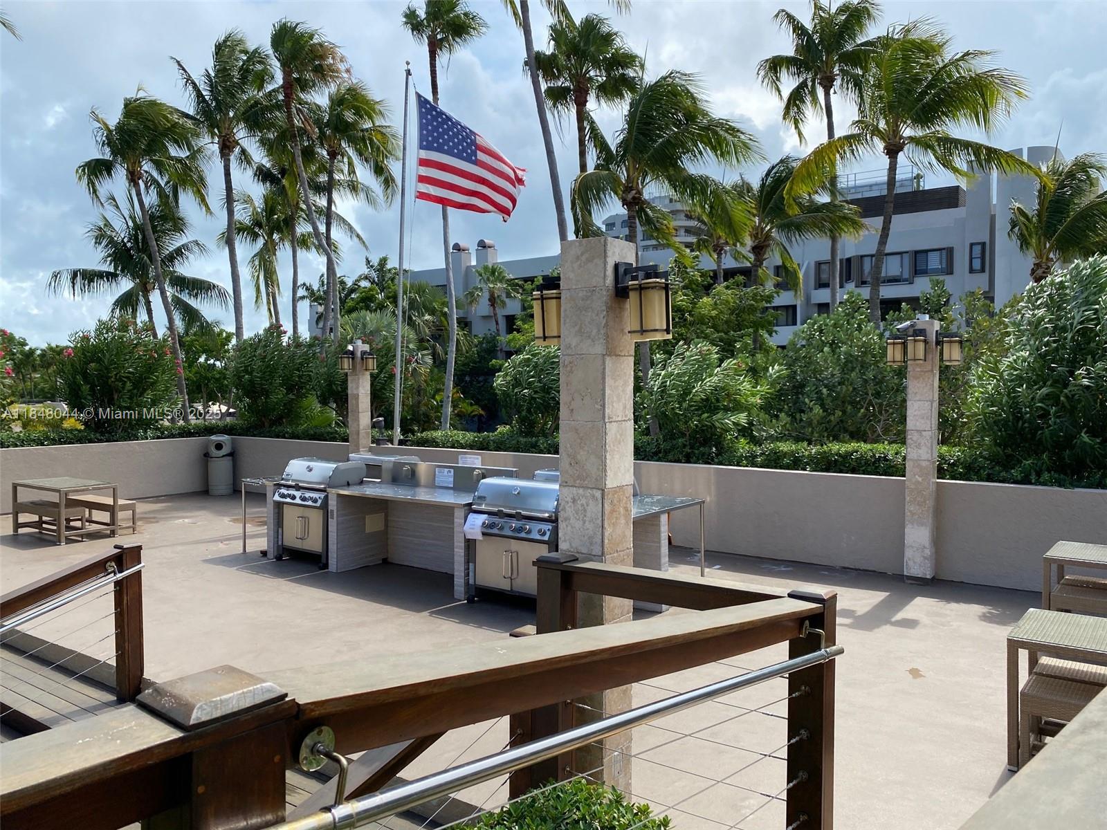 251 Crandon Boulevard, Unit 243 Key Biscayne, FL 33149 - Photo 22 of 23 a view of house with outdoor seating and city view