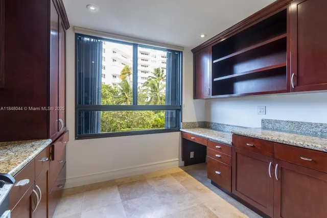 a kitchen with granite countertop wooden cabinets and a sink