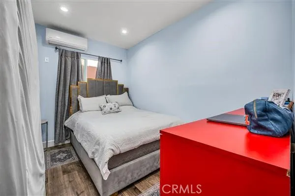 a bedroom with a bed and window
