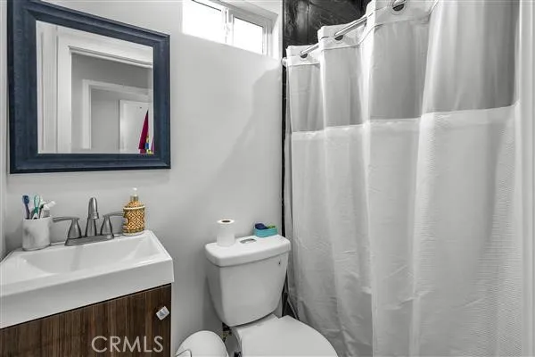 a bathroom with a sink mirror and toilet