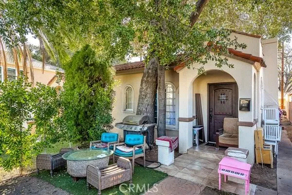 a view of a patio with couches table and chairs and potted plants