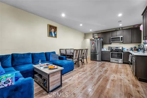 a living room with furniture and kitchen view