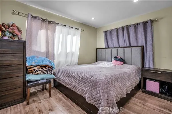 a bed sitting in a bedroom next to a window