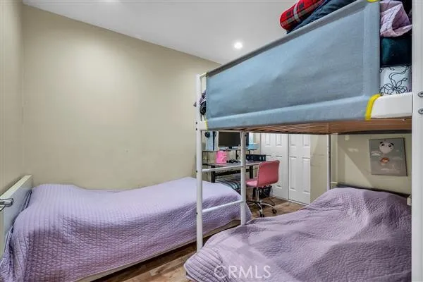 a bedroom with a bed and large windows