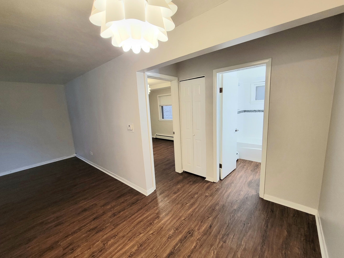 6046 West Pershing Road, Unit 4 Cicero, IL 60804 - Photo 4 of 8 an empty room with wooden floor and windows