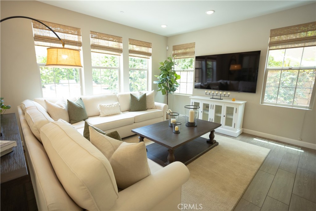 17 Honeysuckle Lake Forest, CA 92630 - Photo 13 of 36 a living room with furniture a flat screen tv and a large window