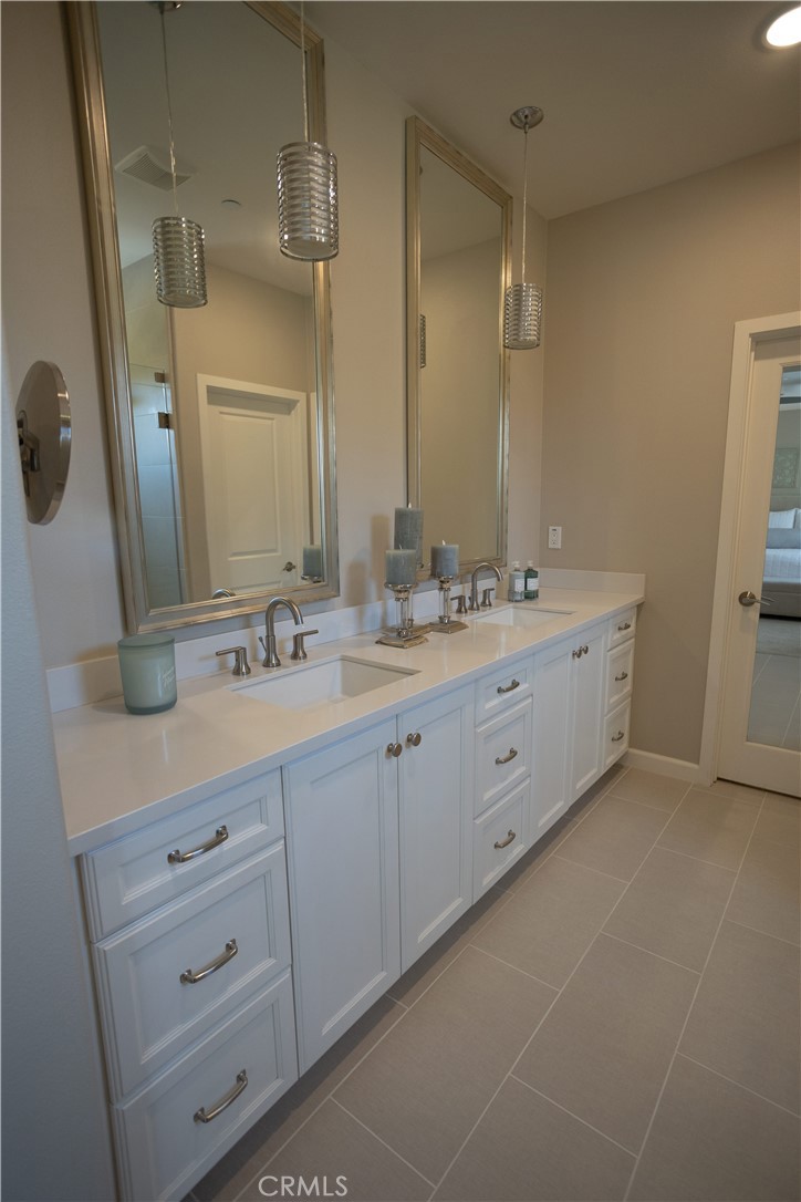 17 Honeysuckle Lake Forest, CA 92630 - Photo 19 of 36 a bathroom with a double vanity sink and mirror