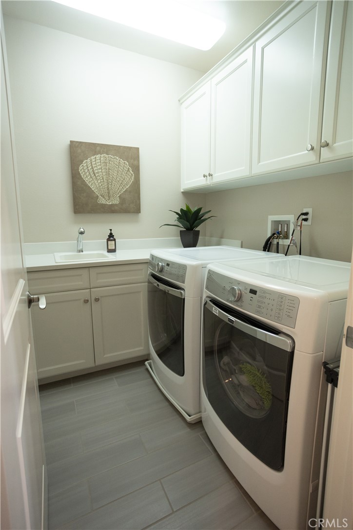 17 Honeysuckle Lake Forest, CA 92630 - Photo 27 of 36 a utility room with sink dryer and washer