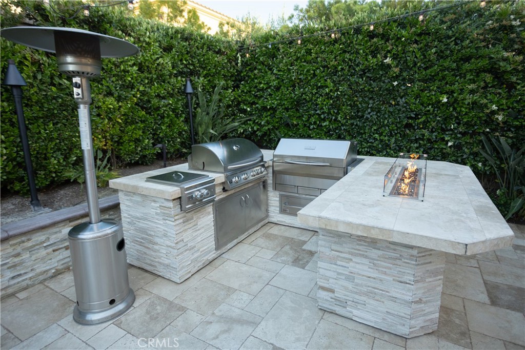 17 Honeysuckle Lake Forest, CA 92630 - Photo 34 of 36 a view of a patio with table and chairs with a barbeque grill and plants