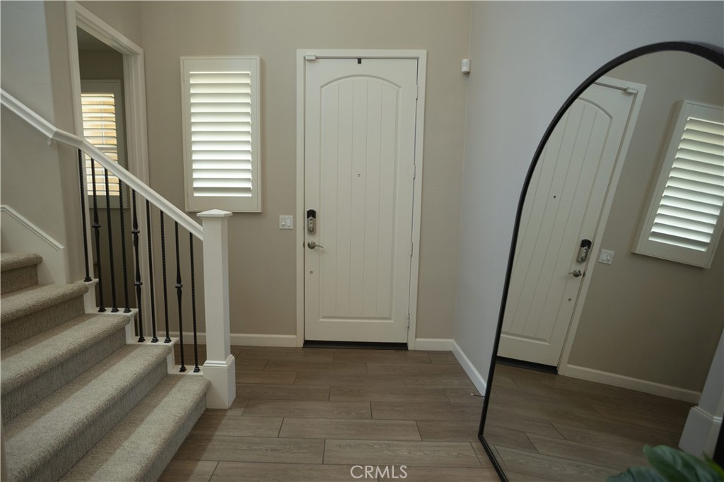 17 Honeysuckle Lake Forest, CA 92630 - Photo 10 of 36 a view of a hallway with wooden floor and entryway