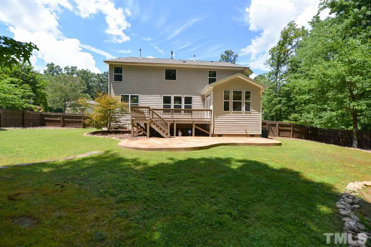 13015 Saxon Way Raleigh, NC 27613 - Photo 29 of 30 a view of a house with a big yard potted plants and a large tree