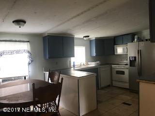 155 Pine Acres Road St. George, GA 31562 - Photo 6 of 8 a kitchen with granite countertop a refrigerator stove top oven and sink