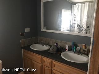 155 Pine Acres Road St. George, GA 31562 - Photo 8 of 8 a bathroom with a sink a mirror and a window