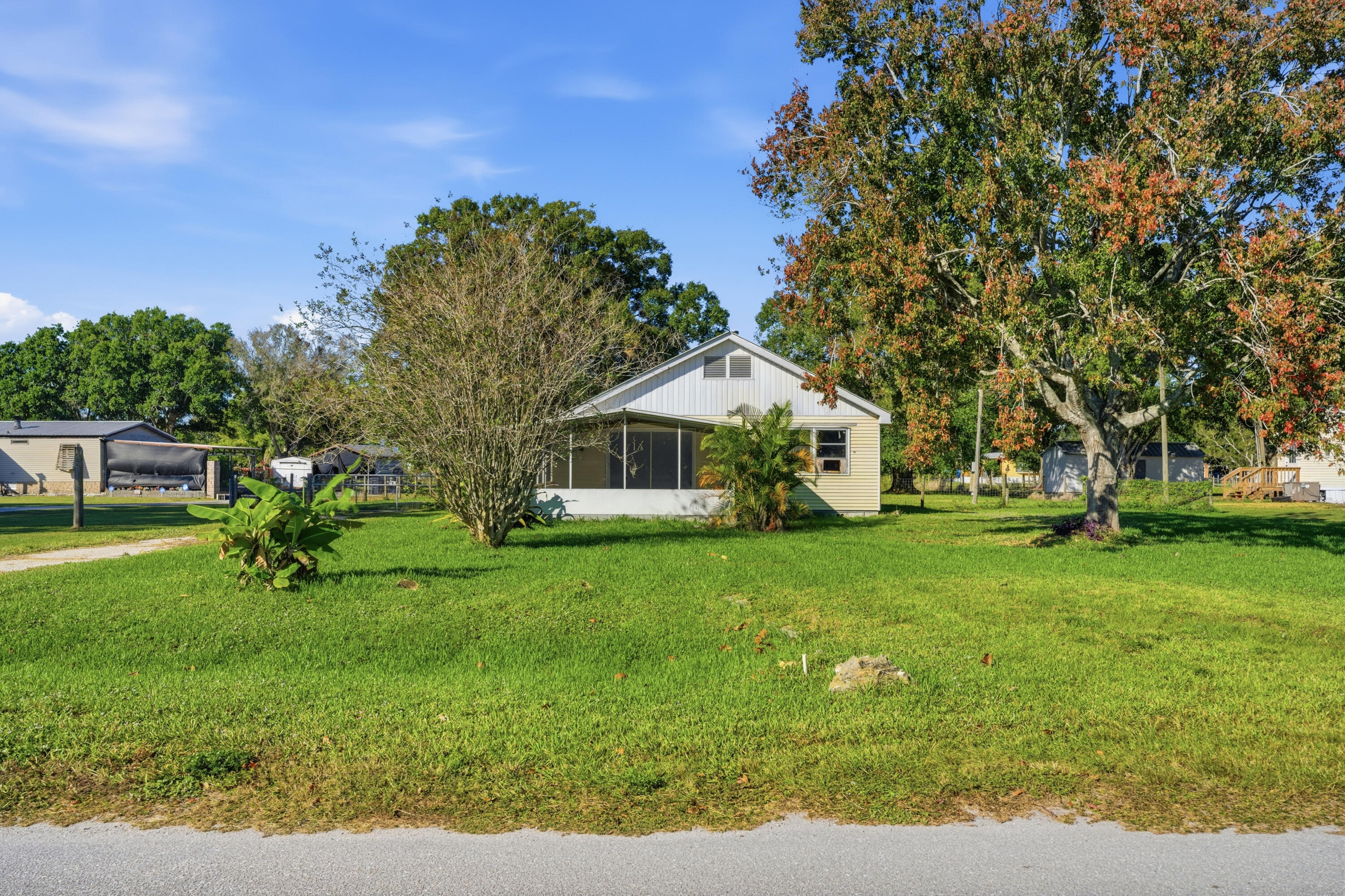 3765 Southwest 13th Terrace Okeechobee, FL 34974 - Photo 1 of 10 a view of a house with backyard and sitting area