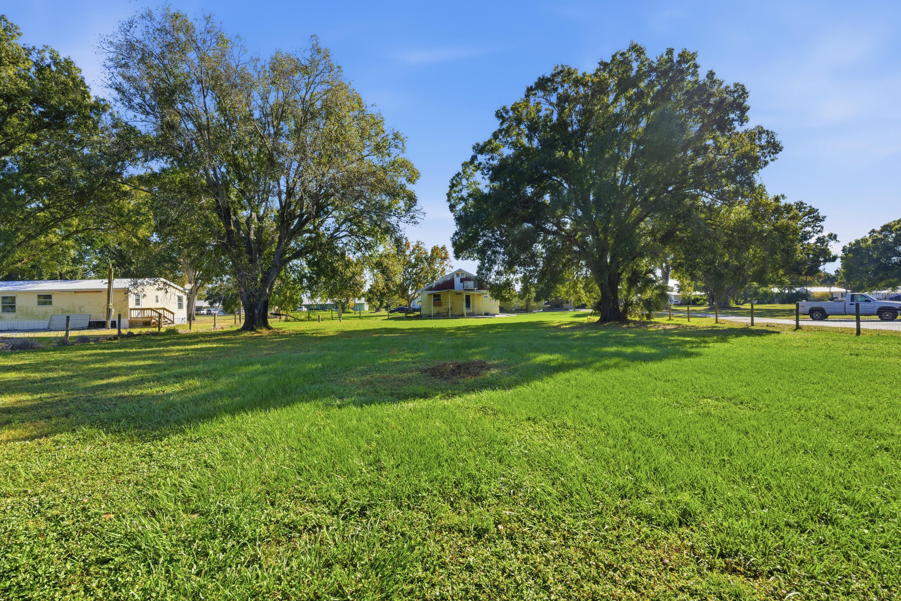 3765 Southwest 13th Terrace Okeechobee, FL 34974 - Photo 2 of 10 a huge green field with lots of trees