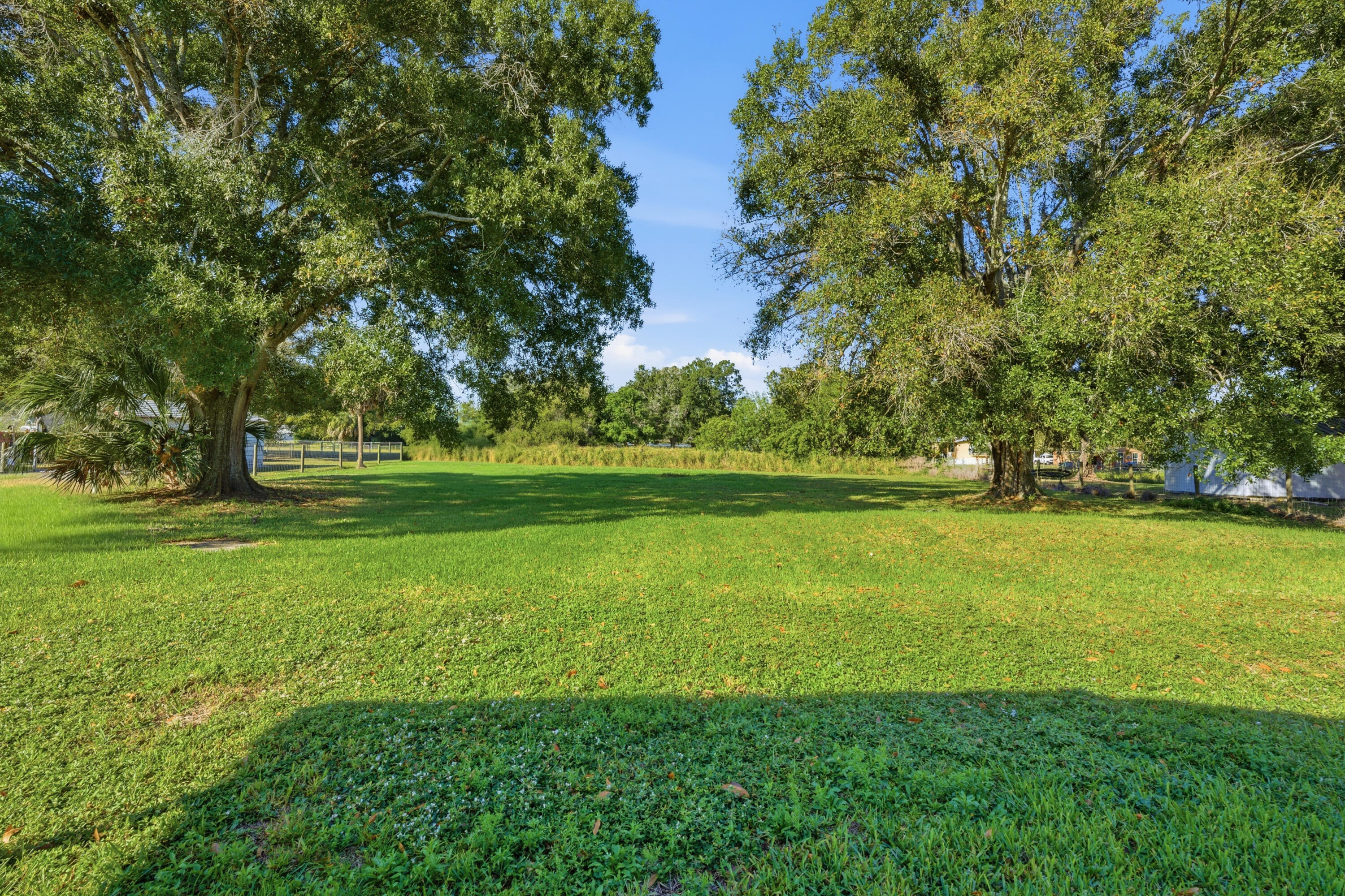 3765 Southwest 13th Terrace Okeechobee, FL 34974 - Photo 3 of 10 a view of outdoor space with green field and trees