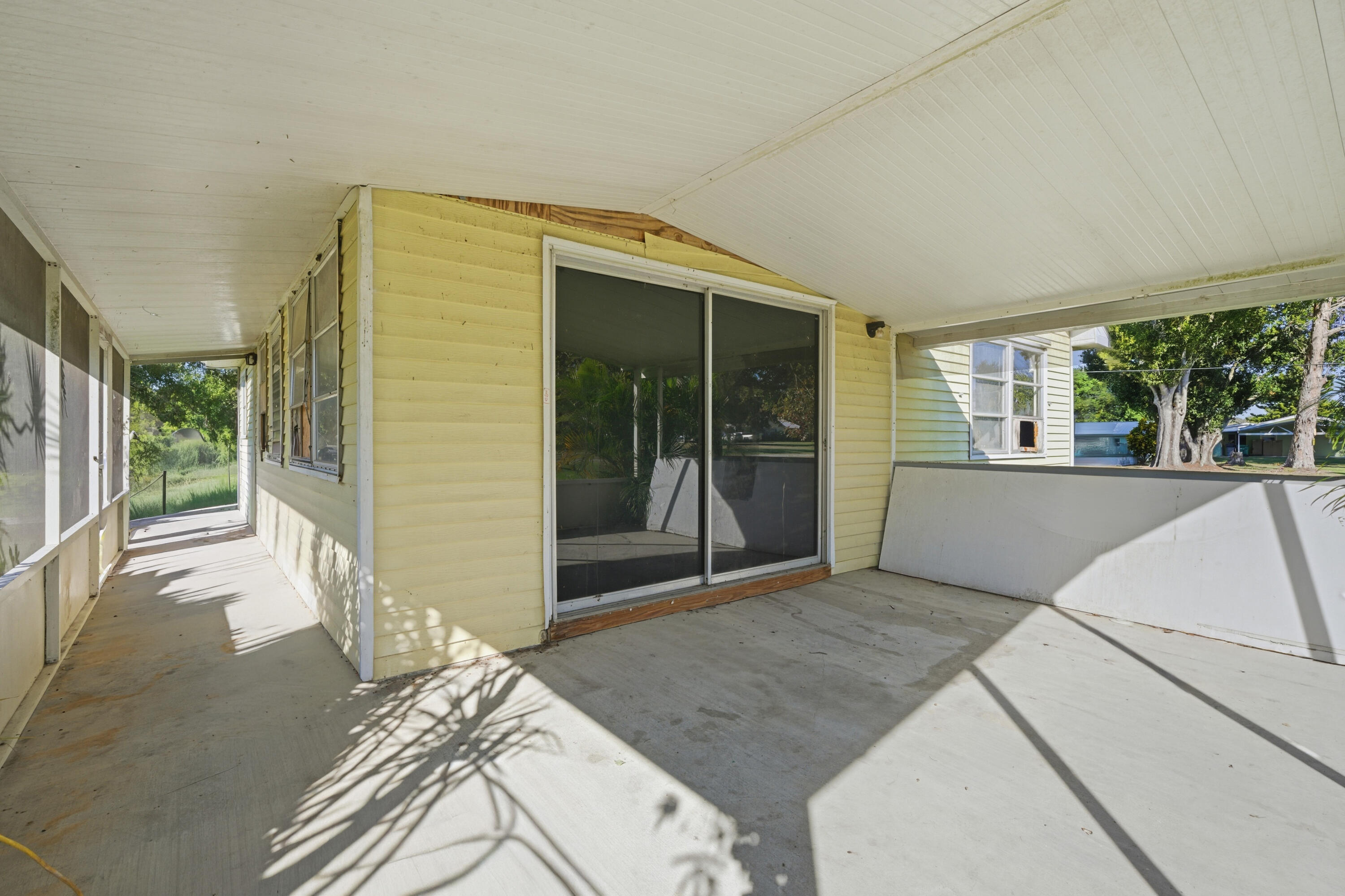 3765 Southwest 13th Terrace Okeechobee, FL 34974 - Photo 7 of 10 a bedroom with a bed and a large window