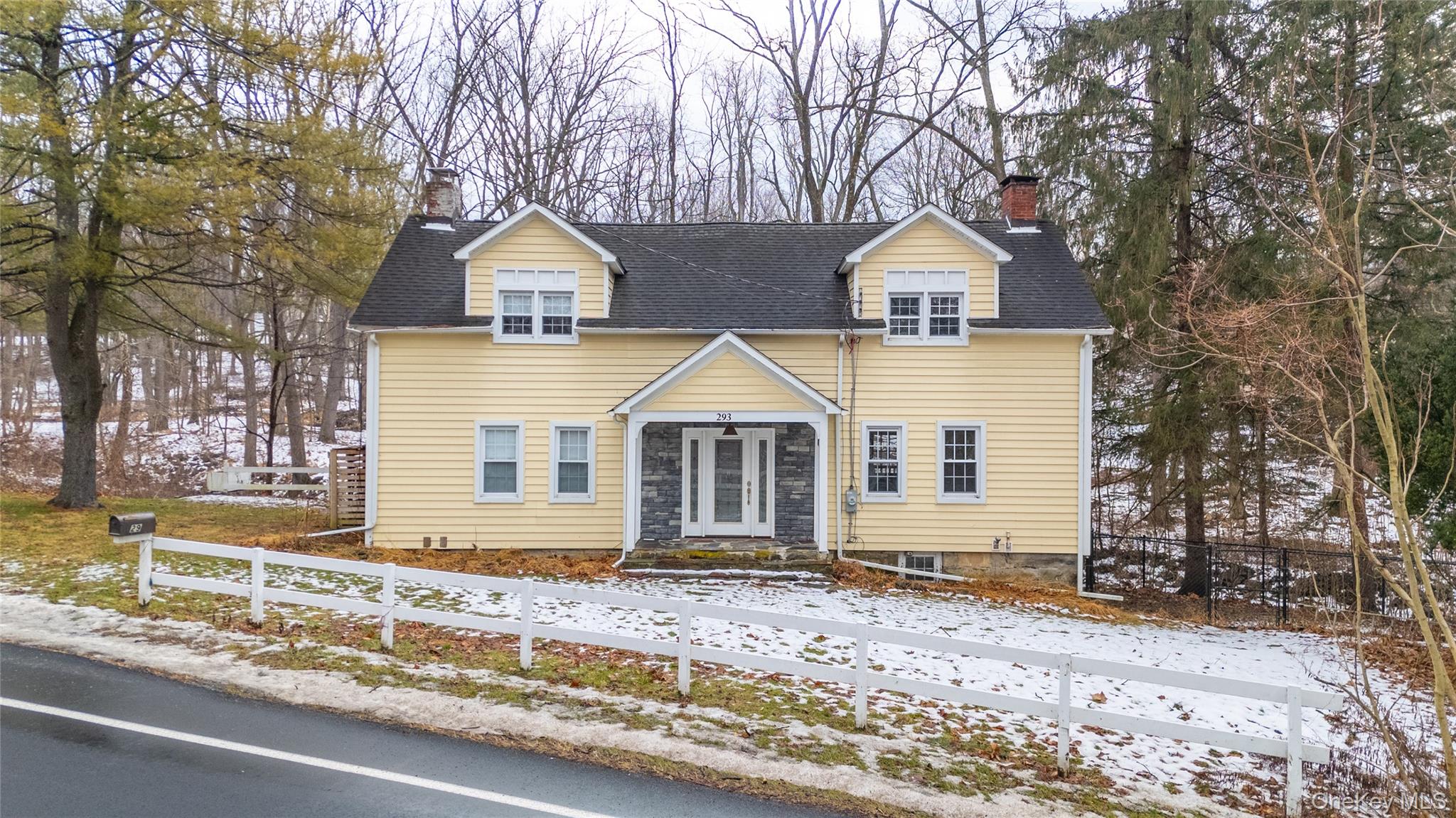 293 Highway 94 Warwick, NY 10990 - Photo 1 of 20 View of front facade with a chimney, a fenced front yard, and a shingled roof